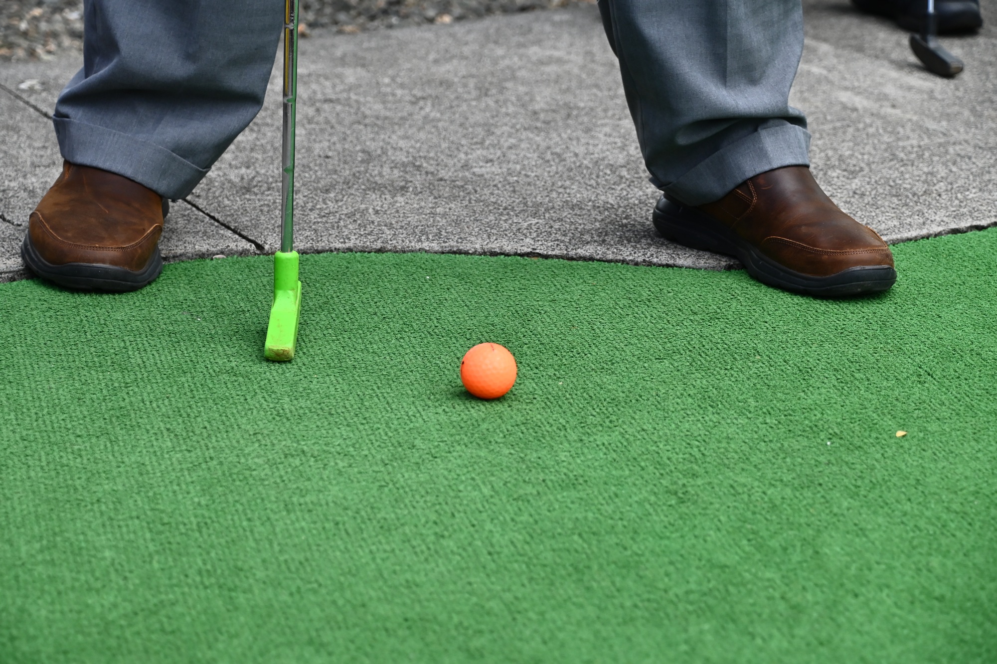 Closeup of a male playing minigolf